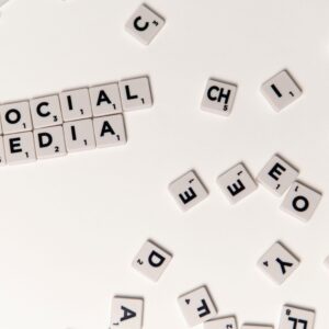 Scrabble tiles spelling 'Social Media' on a white background, symbolizing digital communication.